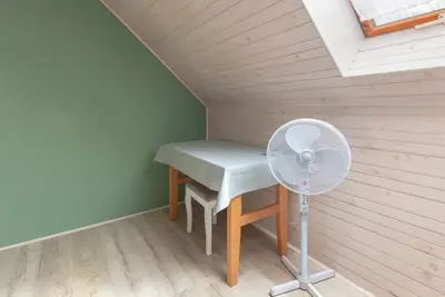a small room with a desk and a fan at Apartma Mikelj in Bohinj