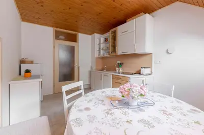 a kitchen with a table with flowers on it at Apartma Mikelj in Bohinj