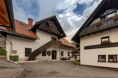 a white building with a brown roof at Apartma Mikelj in Bohinj