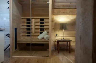 a room with a sauna with a table and a lamp at Marjeta in Begunje na Gorenjskem