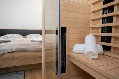 a bedroom with a bed and a glass wall at Marjeta in Begunje na Gorenjskem