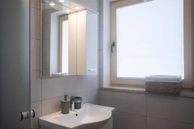 a bathroom with a sink and a mirror at Marjeta in Begunje na Gorenjskem