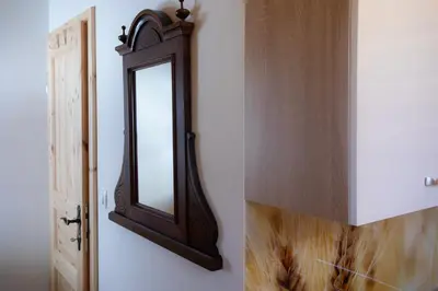 a mirror on a wall next to a door at Marjeta in Begunje na Gorenjskem