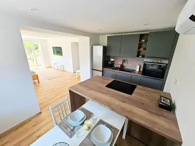 a kitchen with a wooden counter top in a room at Charming Bella Hideout - Adults Only in Jesenice