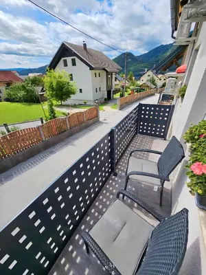 a balcony with two chairs and a table at Charming Bella Hideout - Adults Only in Jesenice