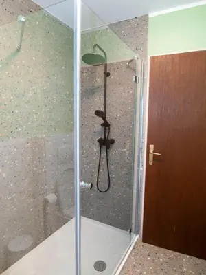 a shower with a glass door in a bathroom at Holiday house Zarja - with sauna and hot tub in Bizeljsko