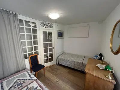 a bedroom with a bed and a desk and a window at Apartma Kresnička in Kobarid