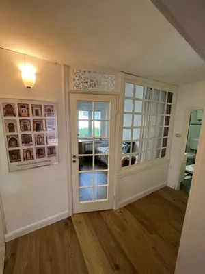 a living room with a door and a window at Apartma Kresnička in Kobarid