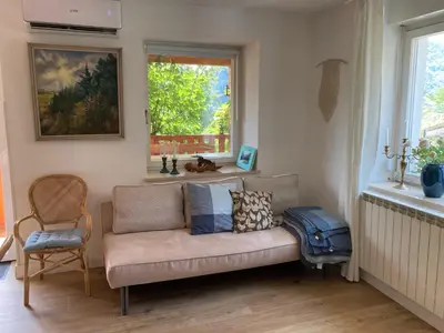 a living room with a couch and a window at Apartma Kresnička in Kobarid