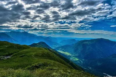 a view of a mountain valley under a cloudy sky at Apartma Kresnička in Kobarid