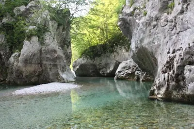 a pool of water in a river with rocks at Apartma Kresnička in Kobarid
