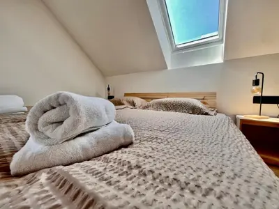 a bedroom with two beds with towels on them at Vila Milan in Bled