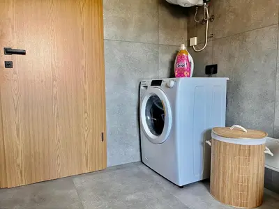 a washer and dryer in a kitchen next to a door at Vila Milan in Bled