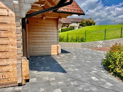 a wooden garage with a roof at Vila Milan in Bled