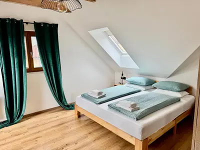 a bedroom with a bed with green curtains at Vila Milan in Bled