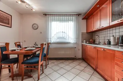 a kitchen with a table and chairs and a window at Apartment Vita in Bled