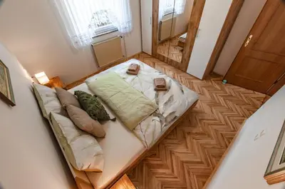 a room with a couch and two glasses on the floor at Apartment Vita in Bled