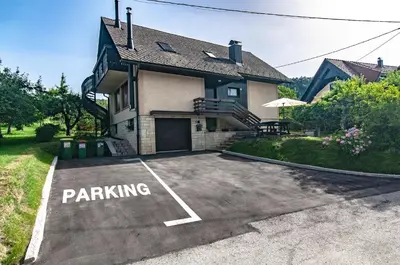 a parking lot in front of a house at Apartment Vita in Bled