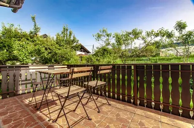 a patio with two chairs and a table on a fence at Apartment Vita in Bled