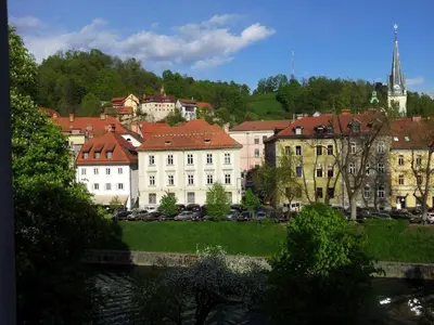 a group of buildings in a city with a river at Studio Ian 1 in Ljubljana