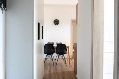 a dining room with black chairs and a table at Apartment Ivana Krško in Krško