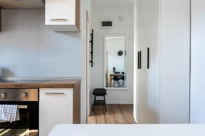 a kitchen with white cabinets and a table at Apartment Ivana Krško in Krško