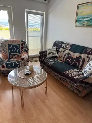 a living room with a couch and a coffee table at Green House Apartment in Pivka