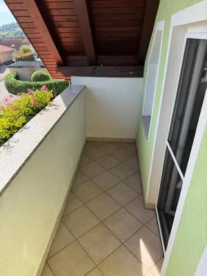 an empty balcony of a building with a patio at Green House Apartment in Pivka