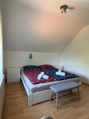 a small bedroom with a bed and a chair at Green House Apartment in Pivka