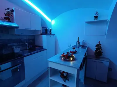 a kitchen with a table with a blue light at Apartment MaRI&BoR-No Stairs, Easy Access, Garage optional in Maribor