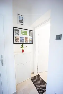 a hallway with a white door and a rug at Apartment MaRI&BoR-No Stairs, Easy Access, Garage optional in Maribor