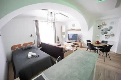 a living room with a bed and a dining room at Apartment MaRI&BoR-No Stairs, Easy Access, Garage optional in Maribor