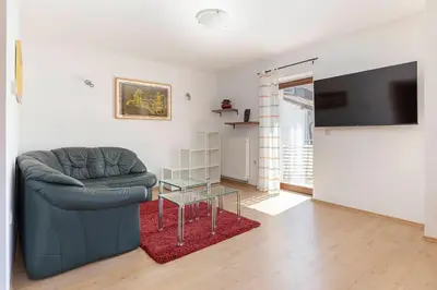 a living room with a couch and a flat screen tv at Vila ART in Ljubljana