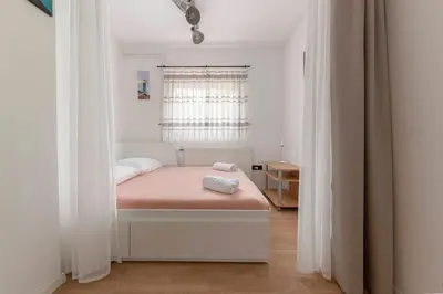 a bedroom with a bed with a pink blanket at Vila ART in Ljubljana