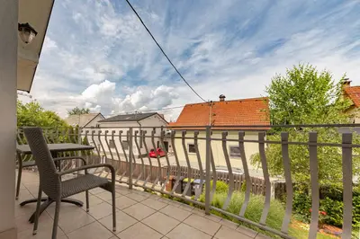 a balcony with a table and a chair on a fence at Vila ART in Ljubljana