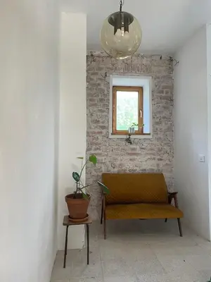 a living room with a bench and a window at 2nd Station Hostel in Bled