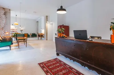 a living room with a desk with a laptop on it at 2nd Station Hostel in Bled