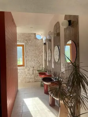 a bathroom with two sinks and two mirrors at 2nd Station Hostel in Bled