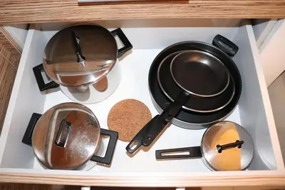 a stove top with pots and pans in a drawer at Apartma Luca, Bovec in Bovec