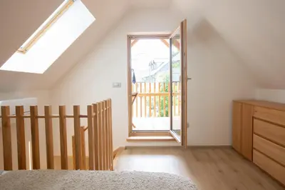 a bedroom with a skylight and a door to a balcony at GUTA in Bled