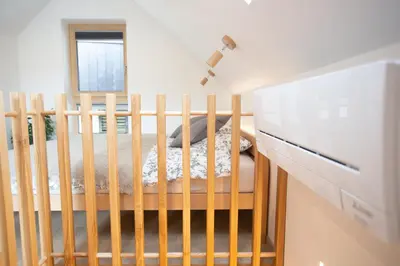 a crib in a room with a window at GUTA in Bled