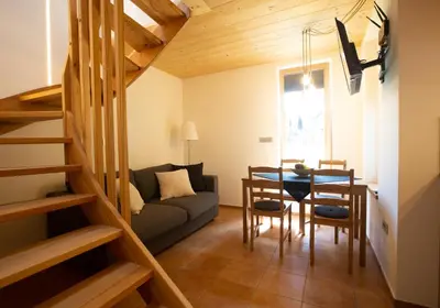 a living room with a table and a couch at GUTA in Bled