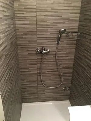 a shower with a shower head in a bathroom at Guest House Golja in Bled