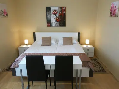 a bedroom with a bed and a table and chairs at Guest House Golja in Bled