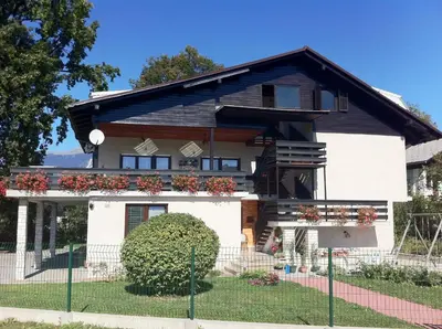 a house with a fence in front of it at Guest House Golja in Bled
