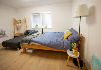 a bedroom with a bed and a chair and a lamp at Casa No. 51 in Kog