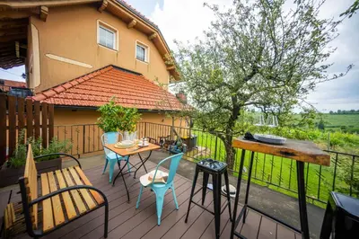 a deck with a table and chairs and a house at Casa No. 51 in Kog