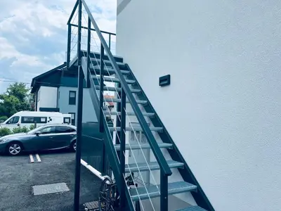 a staircase leading up to a building with a car at Villa Kovačeva apartments, Marice Kovačeve 15, app 1, free parking in Ljubljana