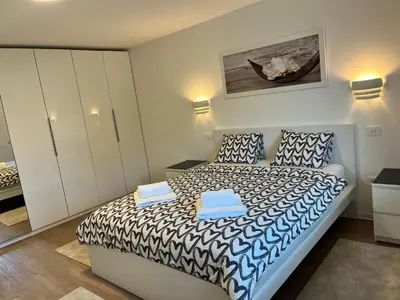 a bedroom with a bed with two towels on it at Villa Kovačeva apartments, Marice Kovačeve 15, app 1, free parking in Ljubljana