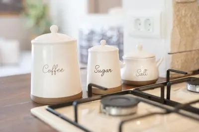 a stove top with three white containers on it at Olga & Ludvik country apartment in Podbrdo